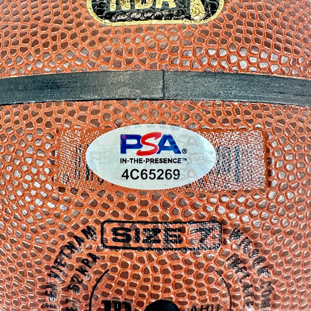 Close-up of a basketball with a PSA grading label and size marking.