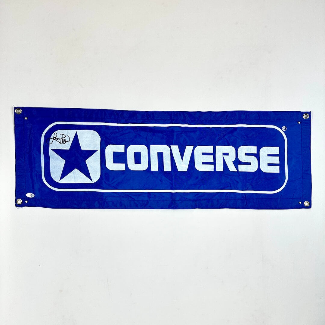 Converse logo on a blue banner against a white background