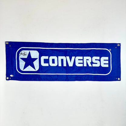 Converse logo on a blue banner against a white background