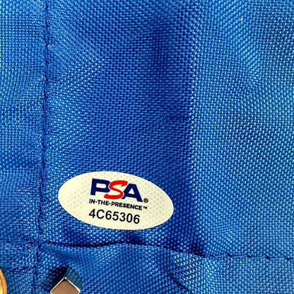 Close-up of a blue fabric with a PSA logo and text on it. 