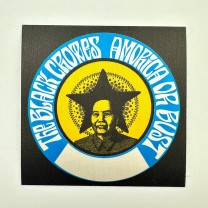 A square black patch featuring a circular graphic with blue outer ring, white text, a yellow center, and a portrait of Mao Zedong inside a star.
