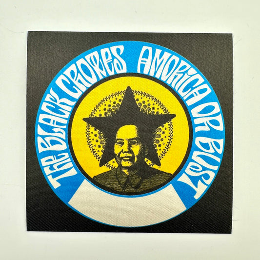 A square black patch featuring a circular graphic with blue outer ring, white text, a yellow center, and a portrait of Mao Zedong inside a star.