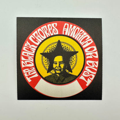 A square black patch featuring a circular graphic with red outer ring, white text, a yellow center, and a portrait of Mao Zedong inside a star.