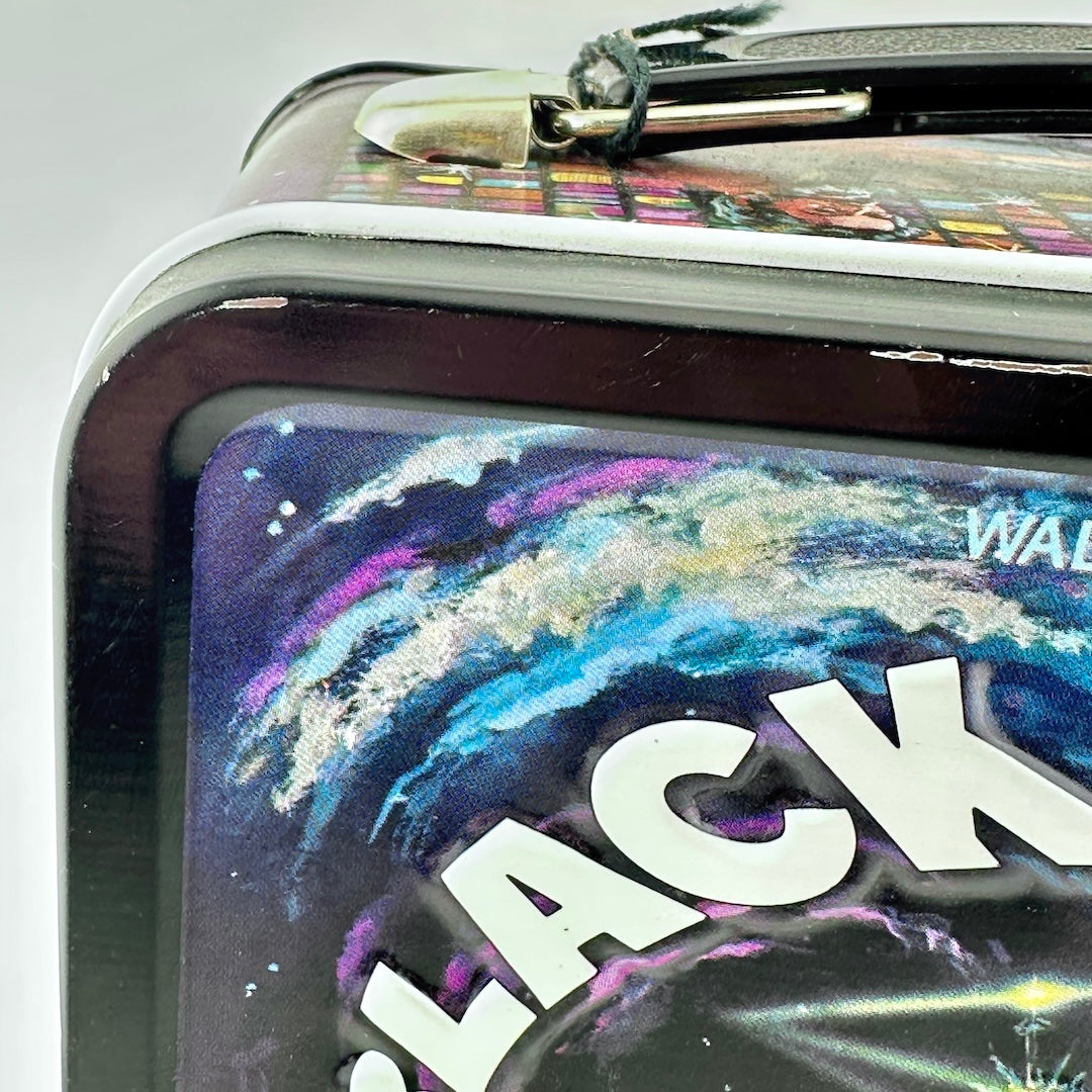 Close-up of a rectangular metal lunch box featuring a colorful galaxy space design.'