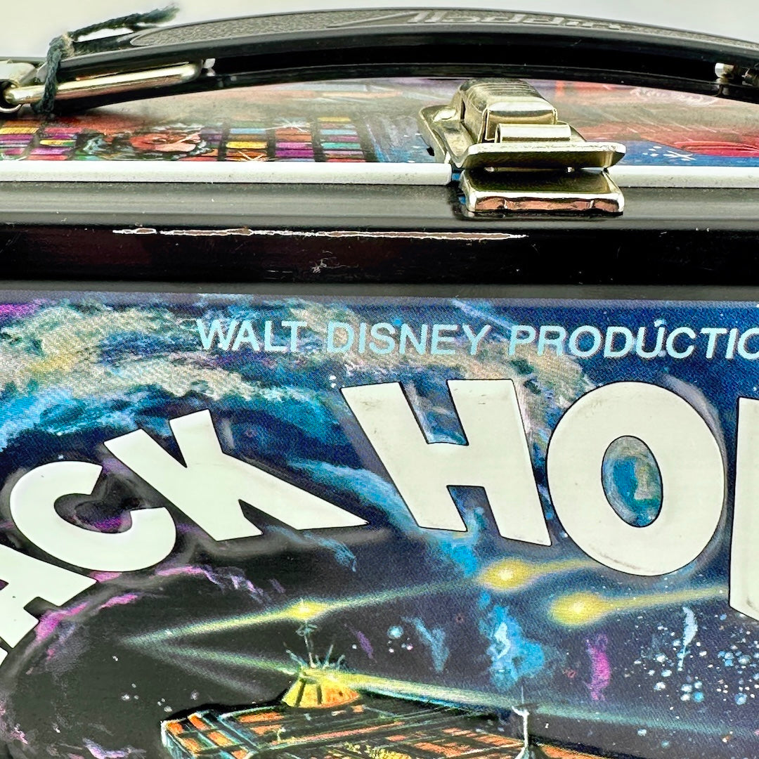 Close-up of a rectangular metal lunch box featuring a colorful galaxy space design.'