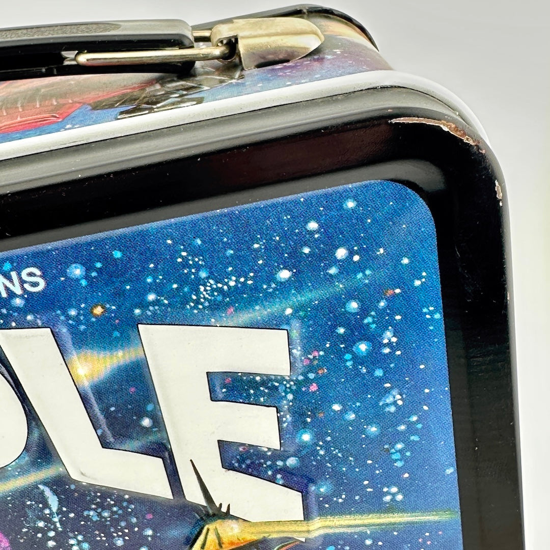 Close-up of a rectangular metal lunch box featuring a colorful galaxy space design.'