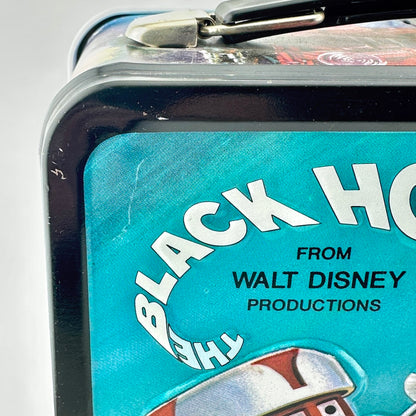Close-up of a vintage Walt Disney Black Hat lunchbox featuring a turquoise blue label with white & black text.