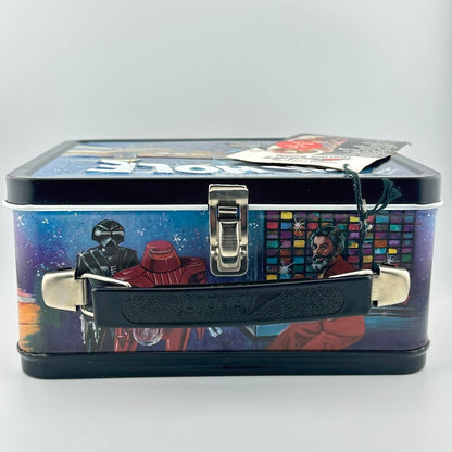 A rectangular metal lunch box with a black handle and latch, featuring a colorful printed design on a blue space-themed background.