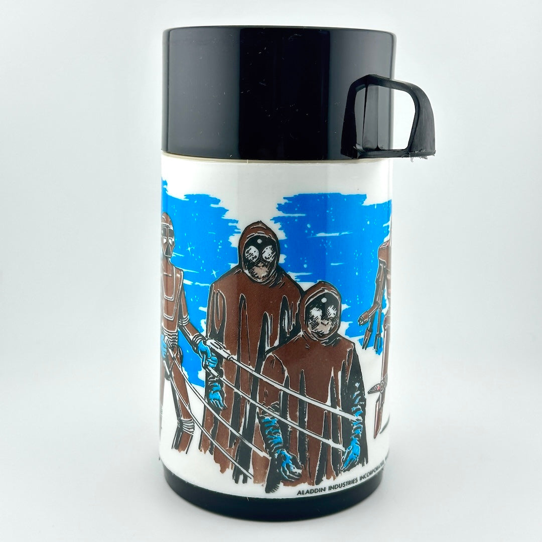 A vintage-style black and white thermos featuring a colorful illustrated wraparound design from Disney's 'Black Hole' film. 