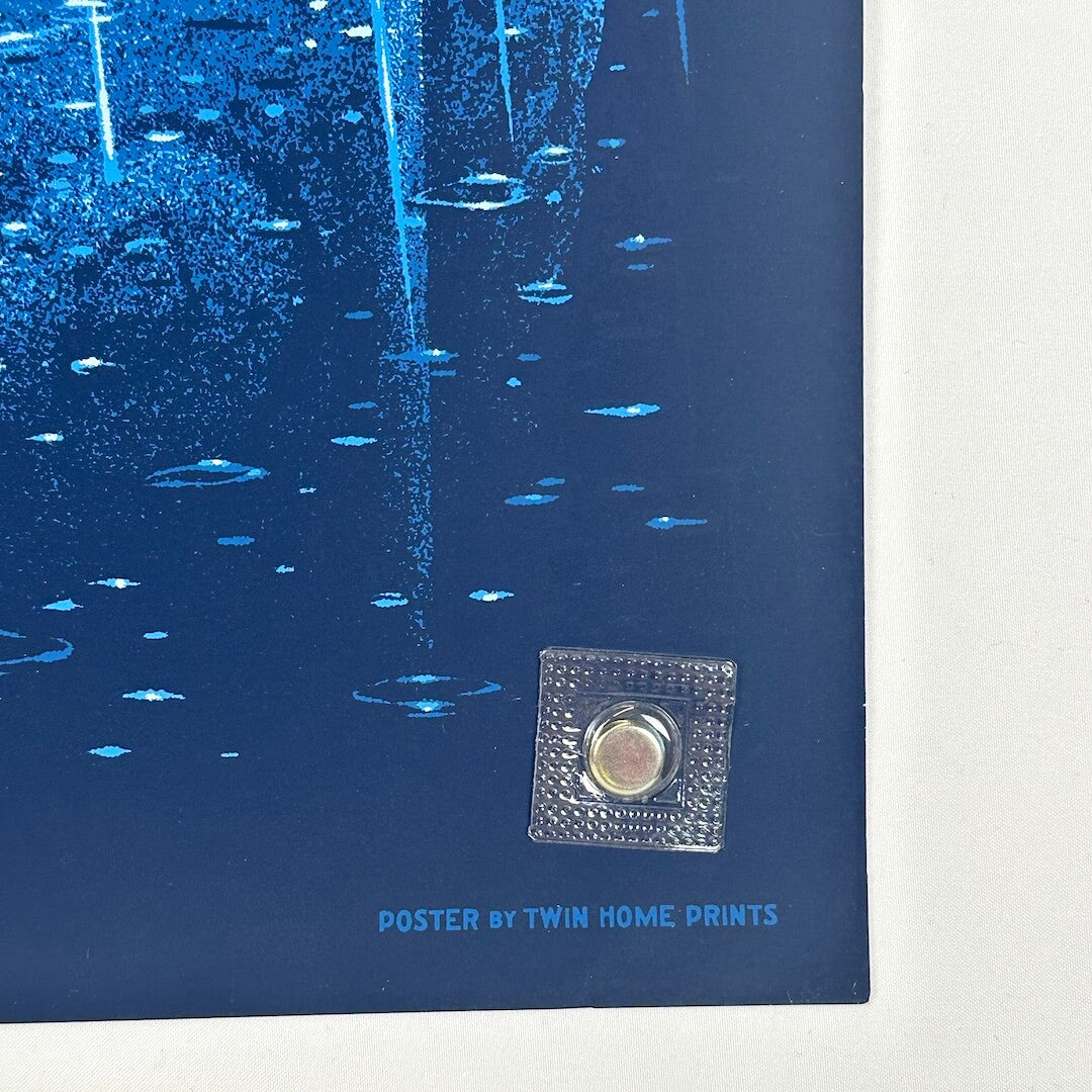 Bottom right corner of poster showing good edges, slight rounded corner. Artist stamp at corner.