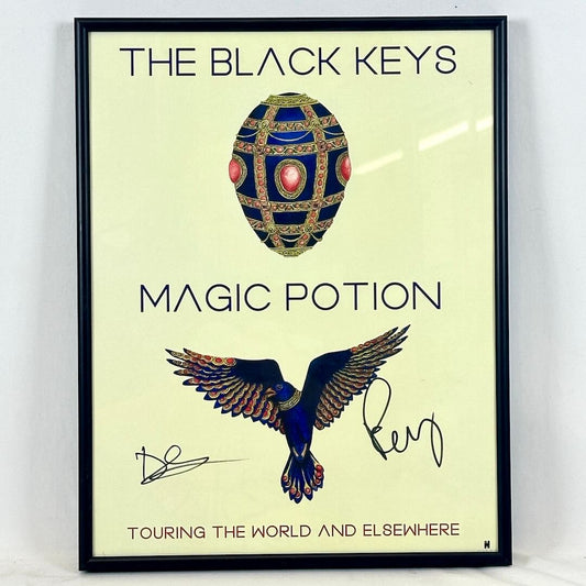 Framed poster for 'The Black Keys Magic Potion' with a decorative egg and bird illustration.