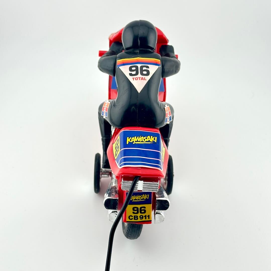 A red and black Kawasaki CB911 toy motorcycle with racing decals, shown from a rear three-quarter view on a white background.