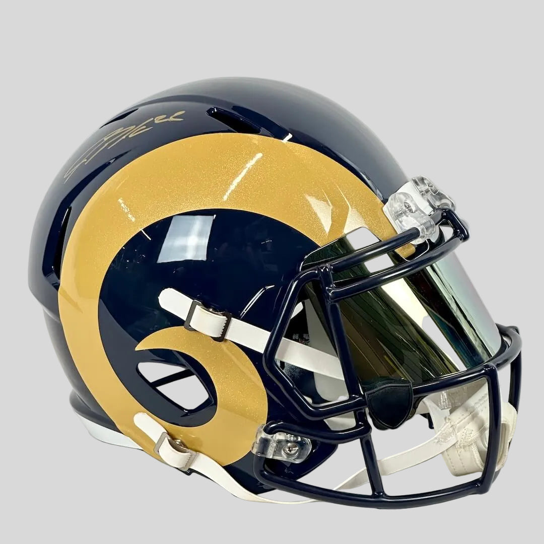 Navy football helmet with gold ram horn on side and signature on top. 