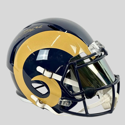 Navy football helmet with gold ram horn on side and signature on top. 