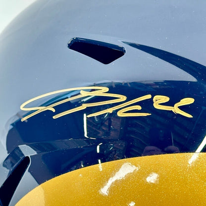Close-up of gold signature on top of helmet. 