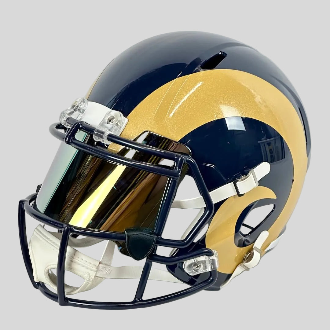 Navy blue football helmet with gold ram's horn on side with mirrored face shield. 