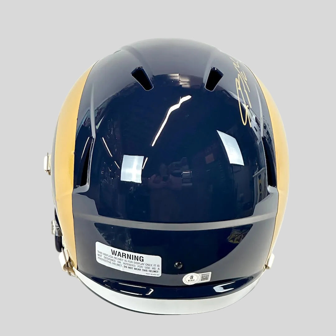 Back view of navy blue football helmet with warning and authentication stickers. 