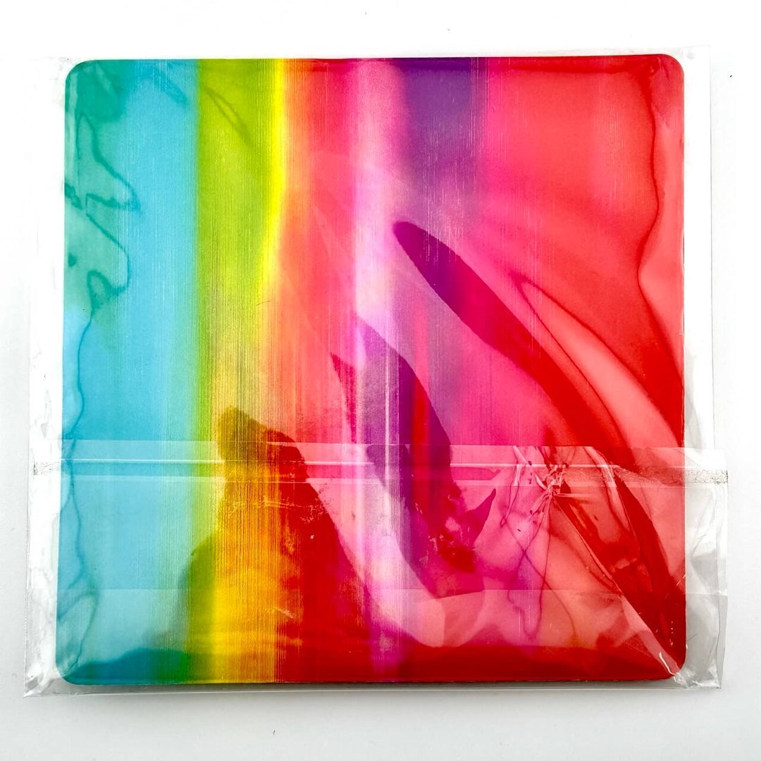 Backside of rainbow ombre card backing, wrapped in plastic.