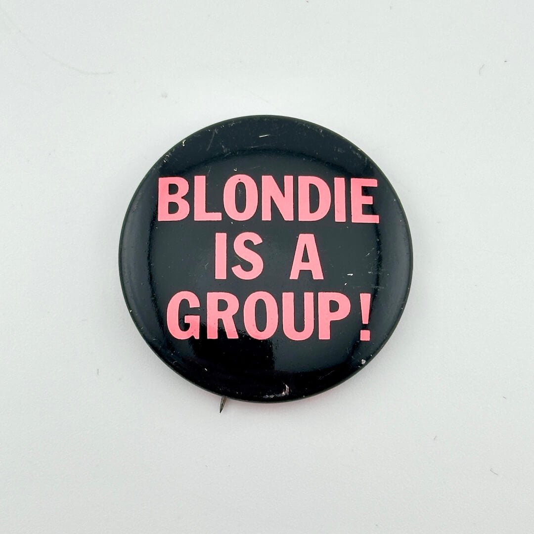 Button badge with 'BLONDIE IS A GROUP!' text on a white background