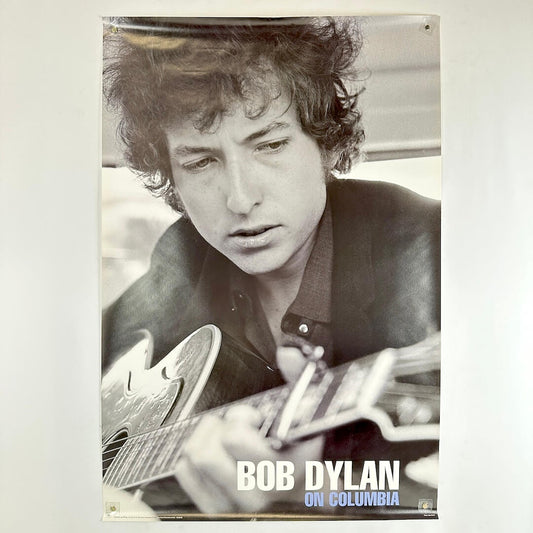 Black and white poster of Bob Dylan playing guitar with text 'Bob Dylan on Columbia'.