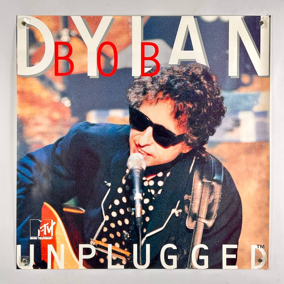 Poster of a musician performing with text 'MTV Unplugged' and 'Dylan' on a gray background
