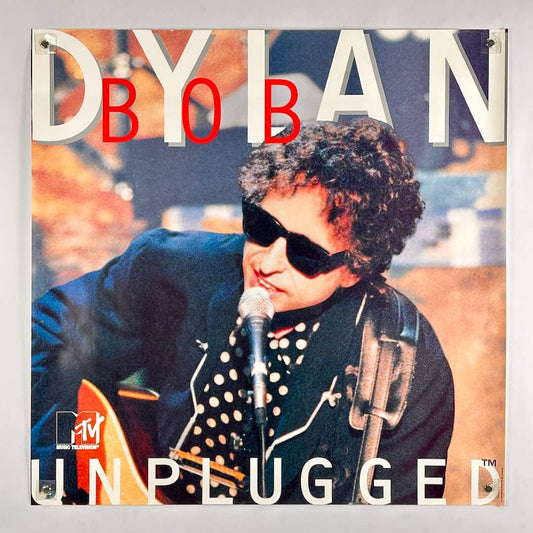 Poster of a musician performing with text 'MTV Unplugged' and 'Dylan' on a gray background