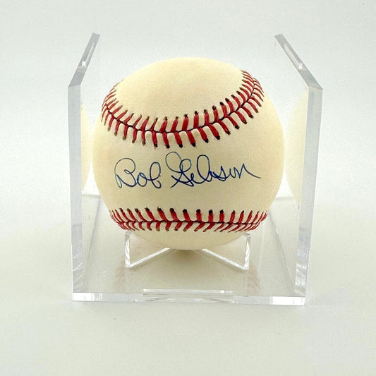 Signed baseball in clear display cube against white background. 