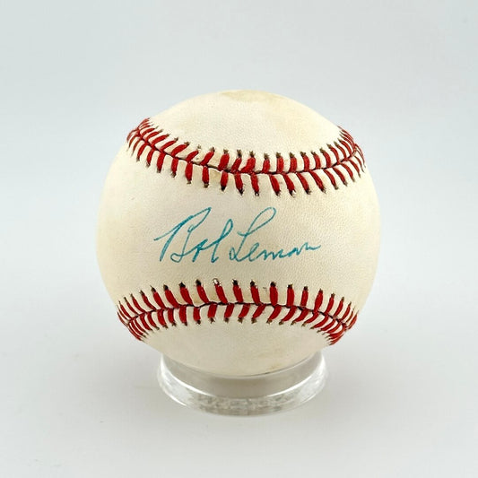 Baseball with red stitching on a white background