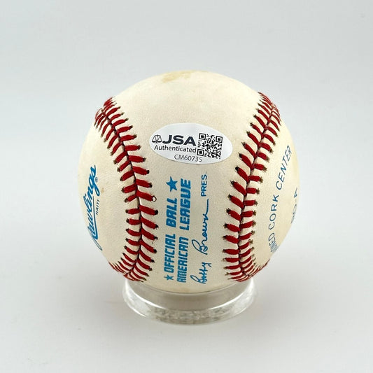 Baseball with red stitching on a white background