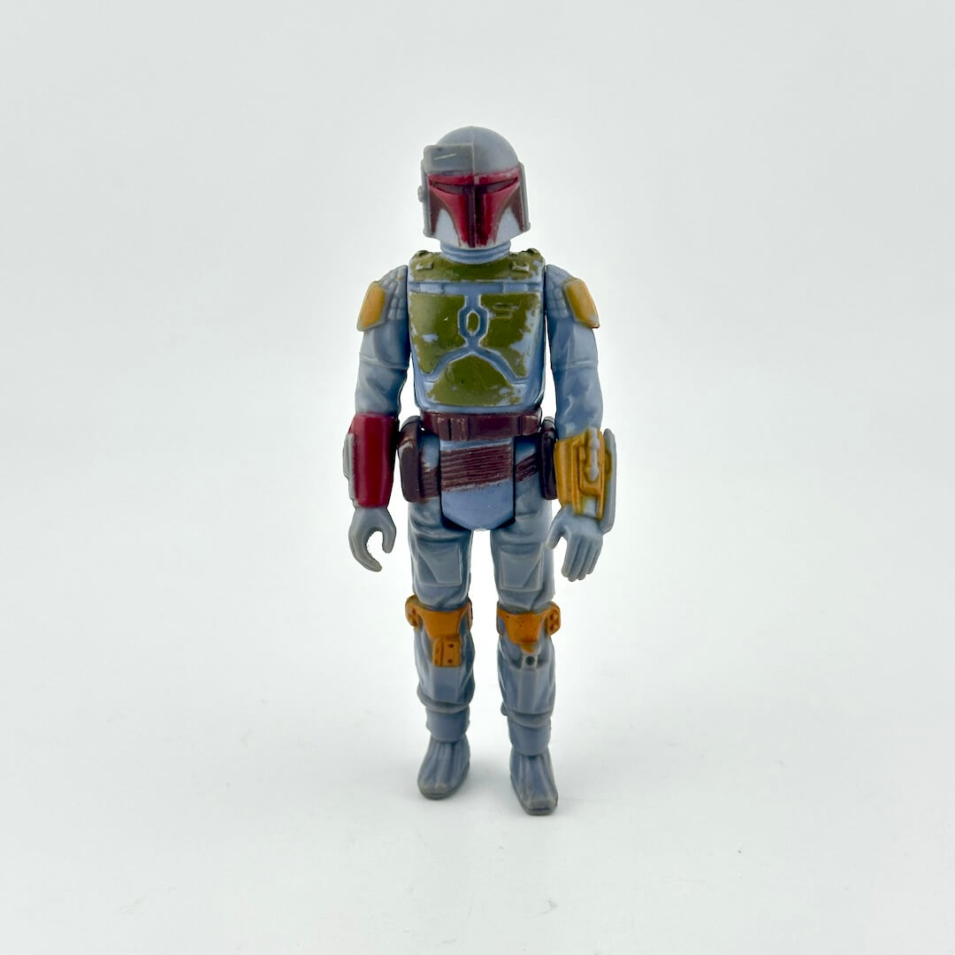 Action figure with a gray and green costume on a white background