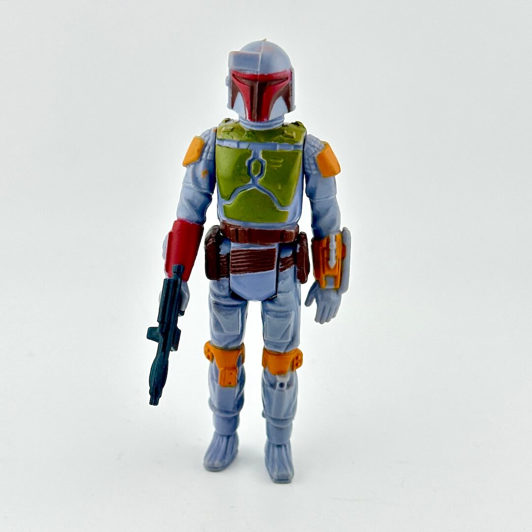 Action figure in battle armor with weapon on white background. 