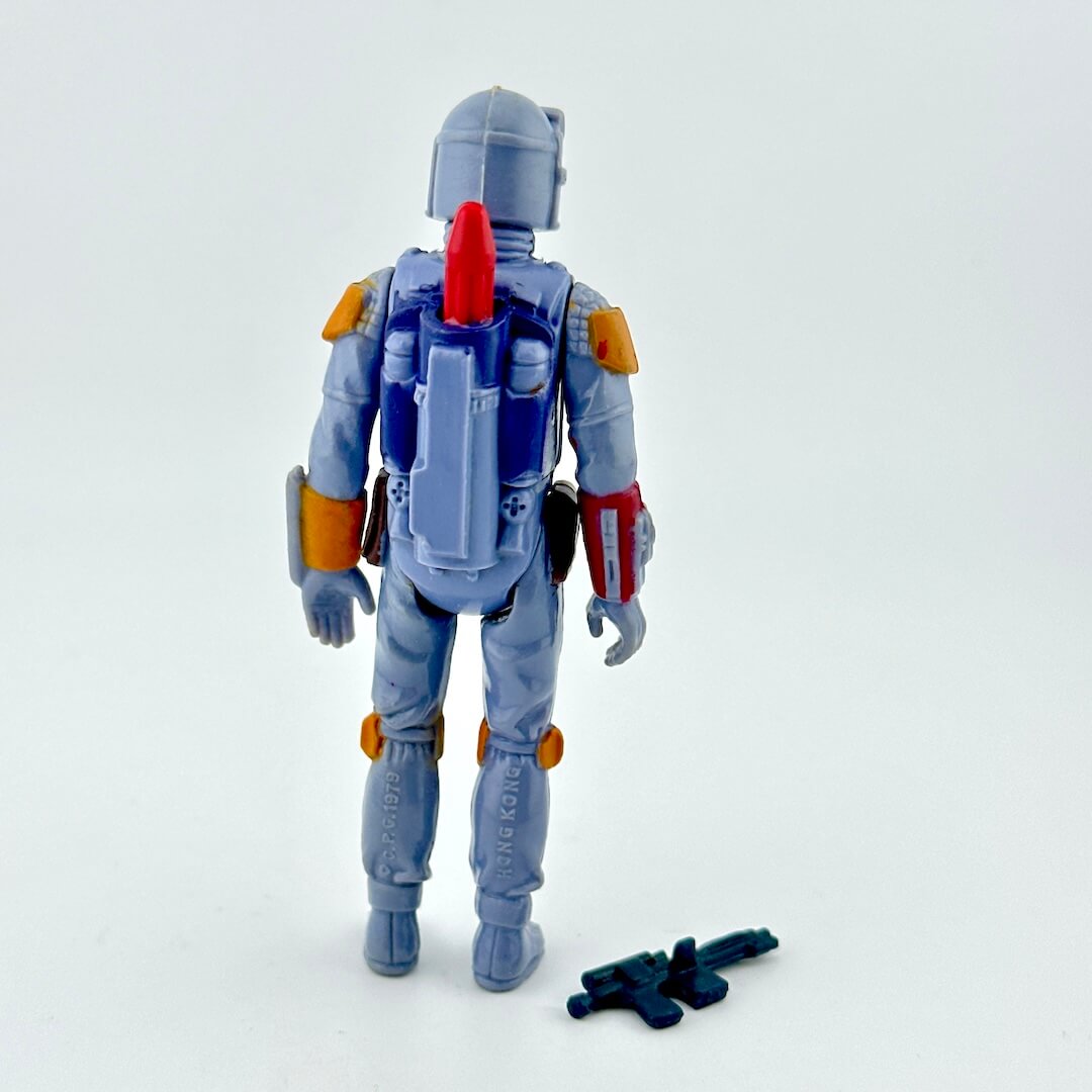 Toy figure with a backpack and weapon on a white background