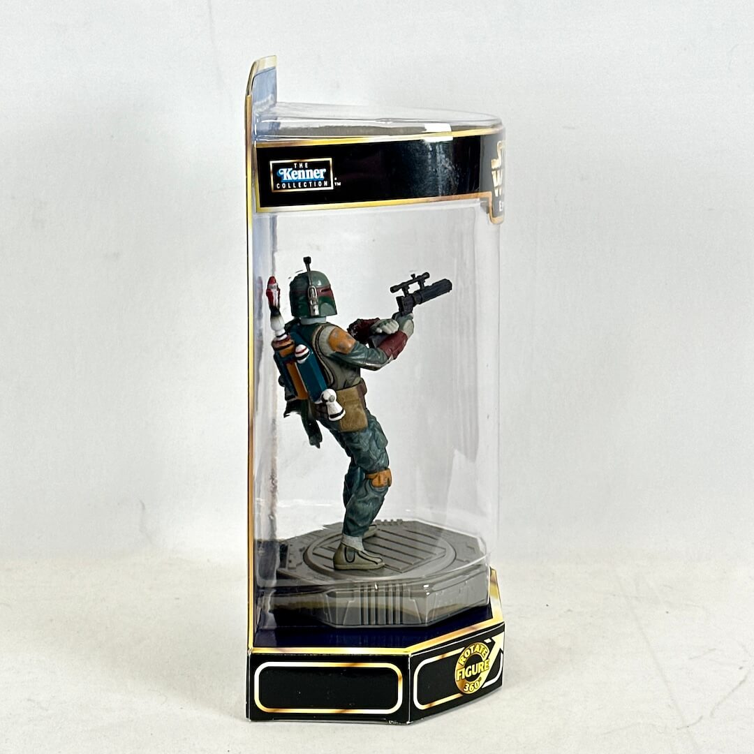 Boba Fett figurine in a transparent display case with Kenner branding on a white background