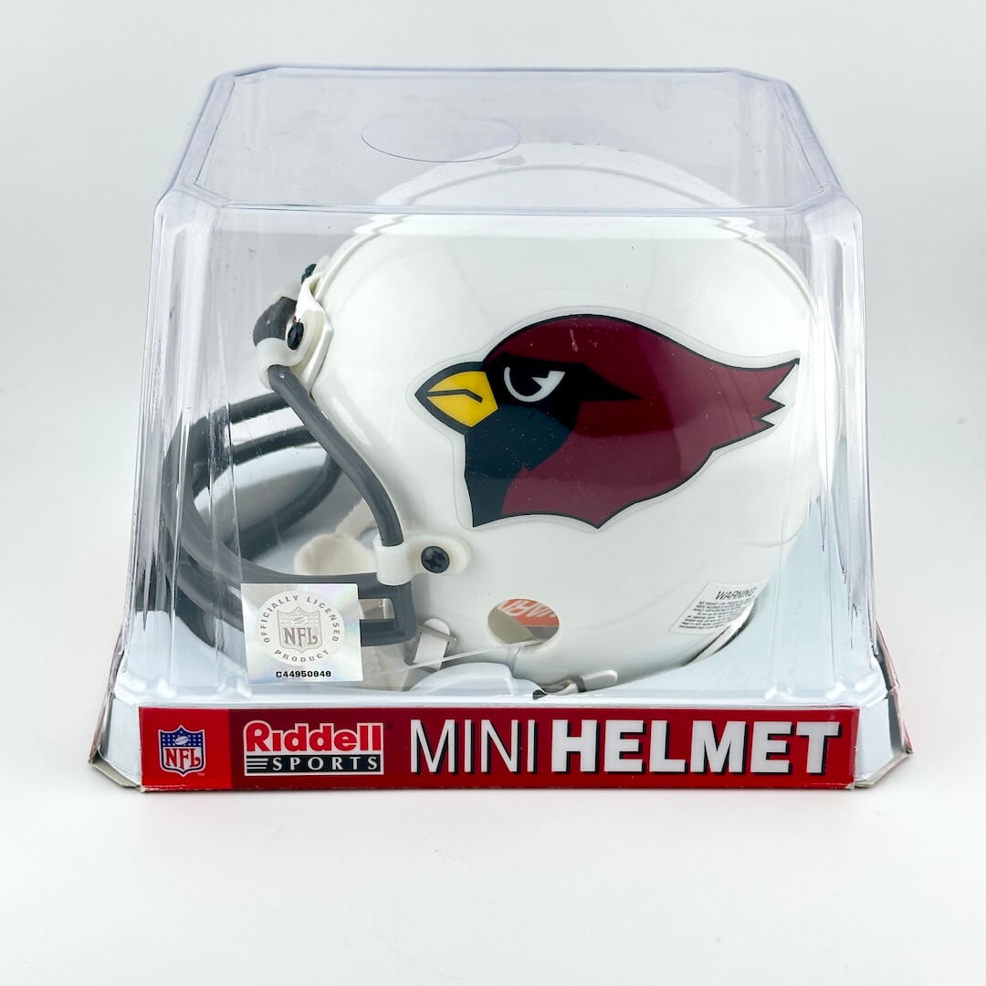 Mini football helmet with team logo in clear packaging on a white background