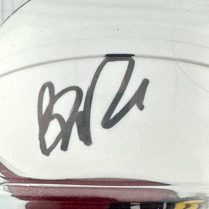 Close-up of a signature on a white surface with a blurred background