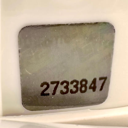 Close-up of authentication sticker with visible number. 