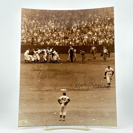 Vintage black and white photograph of a baseball game with players on the field and a crowd in the stands.