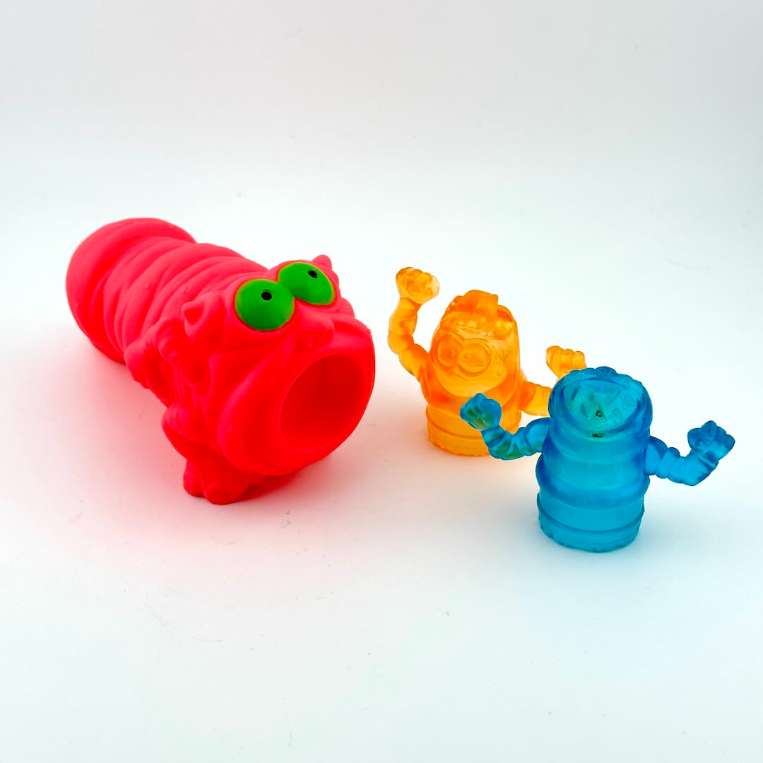 Three colorful plastic toys on a white background