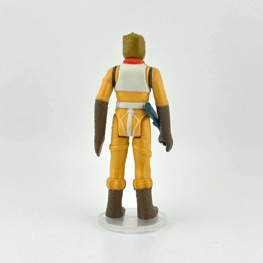 Action figure in a yellow and brown outfit on a white background