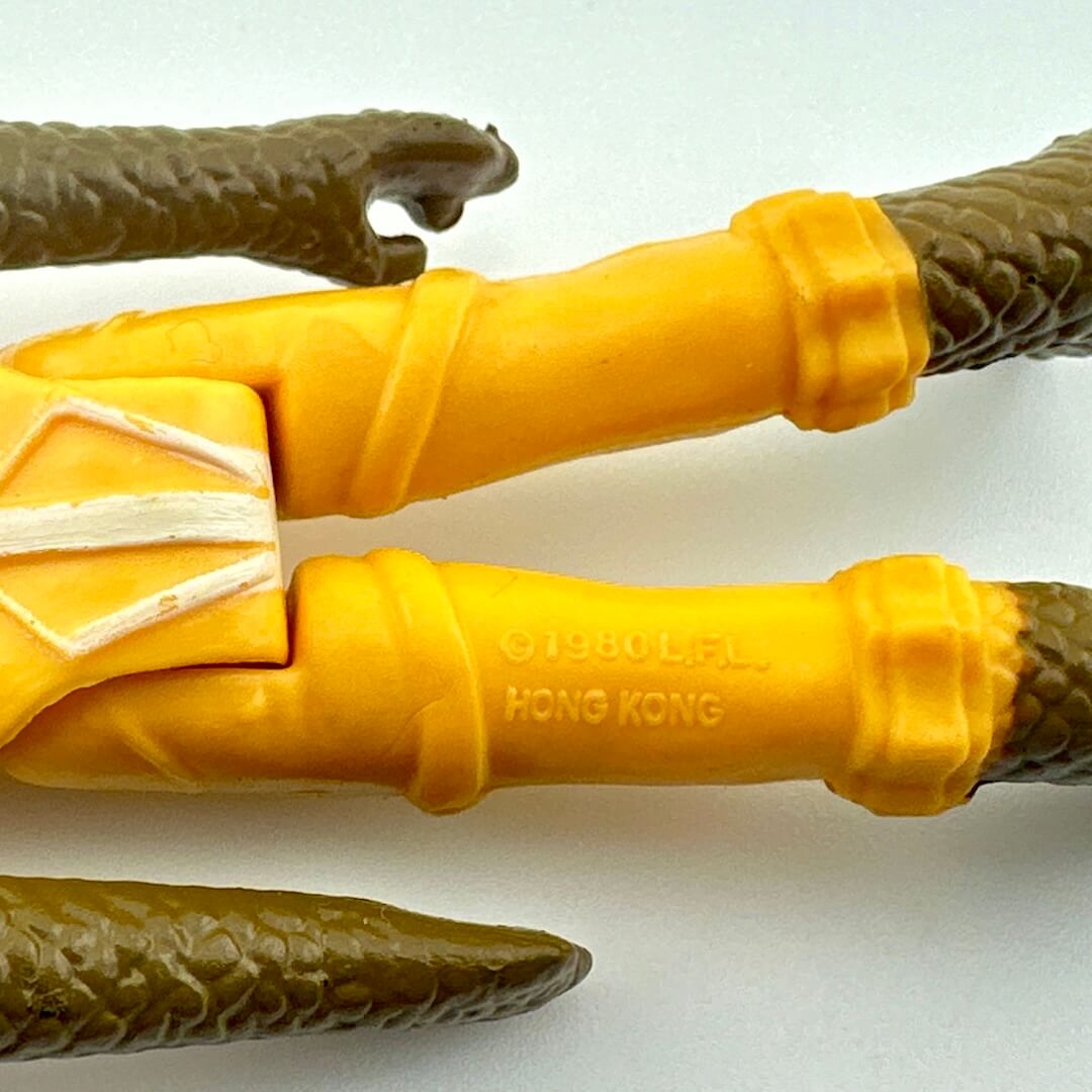 Close-up of a toy figure's legs with the COO and copyright information. 