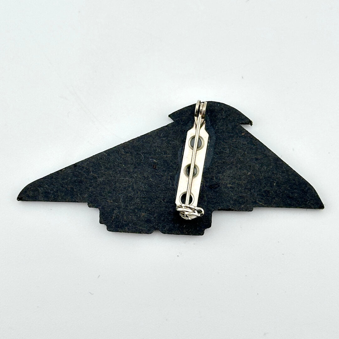 Backside of pin against white background.