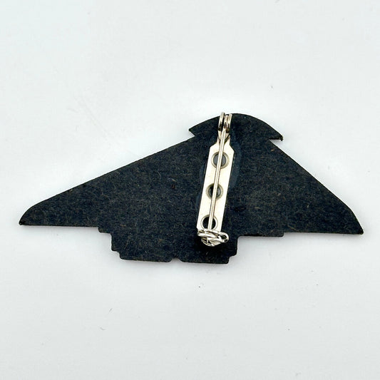 Backside of pin against white background.