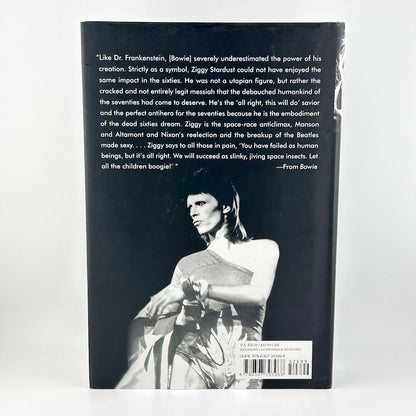 Book back cover with text and a black and white photo of a person holding a gun.