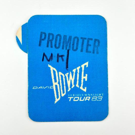 Rectangular, blue fabric pass with David Bowie branding and "promoter" stamp. 