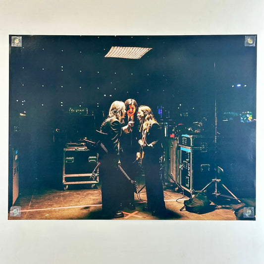 Poster of three women around microphone in sound studio. 