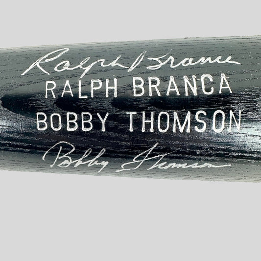 Baseball bat with autographs of Ralph Branca and Bobby Thomson on a white background