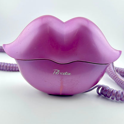 A vintage purple lips-shaped telephone receiver, featuring the 'Bratz' brand name in silver script on the front.