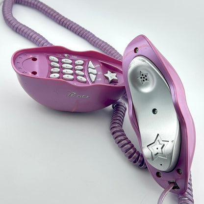 A purple corded telephone with a matching coiled cord, shown open to reveal the silver inner receiver and keypad details.