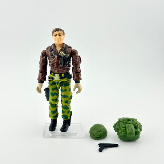 GI Joe action figure in camouflage military gear with accessories on white background. 