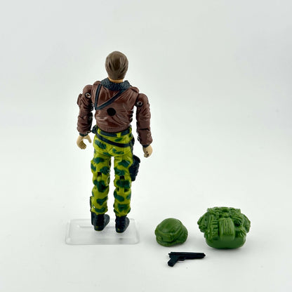 GI Joe action figure in camouflage military gear with accessories on white background. 
